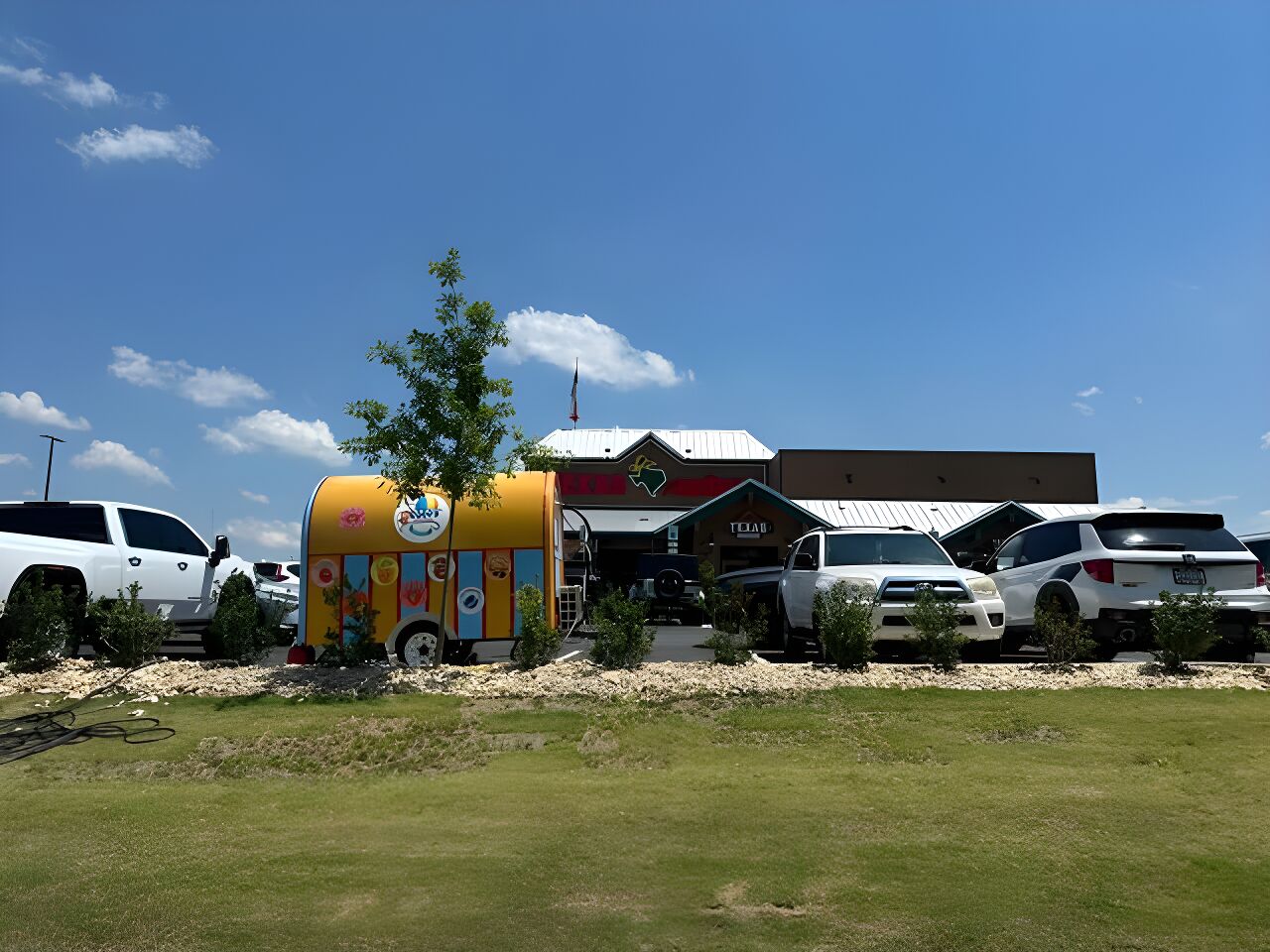The Mini set up in a restaurant parking lot for a family event